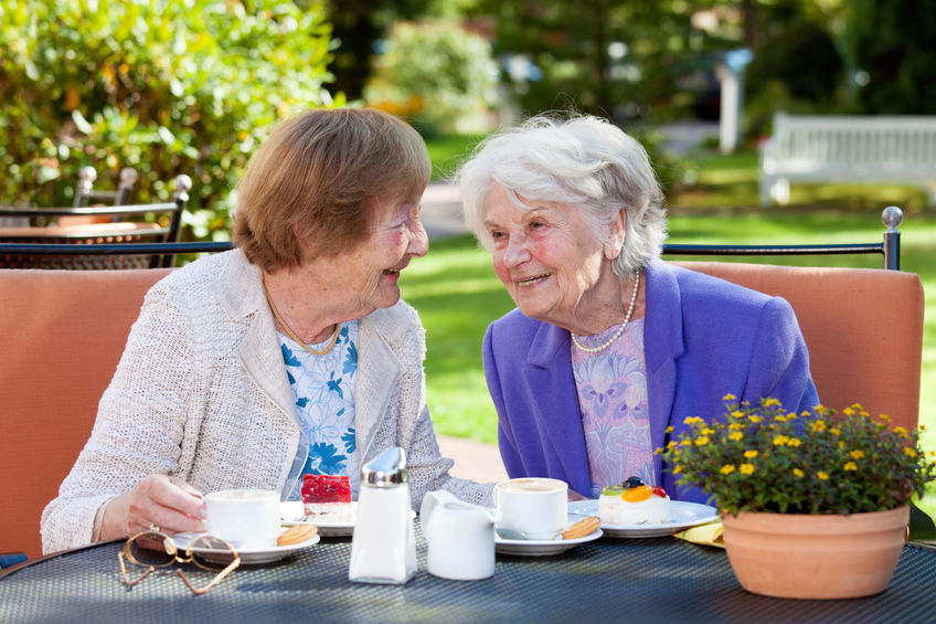 Two Senior Women Relaxing at the Outdoor Table